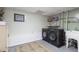 This laundry room features a new washer and dryer with storage shelves and tiled floors at 151 Berkshire Dr, Hiram, GA 30141