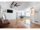 Spacious living room featuring vaulted ceilings, a ceiling fan, and shiny hardwood flooring at 151 Berkshire Dr, Hiram, GA 30141