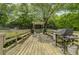 Spacious outdoor grilling area with multiple stations on a wood deck surrounded by trees at 1501 Clairmont Rd # 1318, Decatur, GA 30033