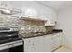 Updated kitchen featuring modern appliances, mosaic backsplash, and ample counter space at 1501 Clairmont Rd # 1318, Decatur, GA 30033