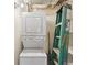 Laundry area with stacked washer and dryer unit and storage solutions at 1501 Clairmont Rd # 1318, Decatur, GA 30033