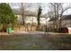 Large gravel backyard, with a wooden fence, and adjacent buildings, ideal for outdoor activities and relaxation at 3581 Midway Rd, Decatur, GA 30032