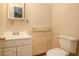 Cozy half-bathroom with a toilet, sink and vanity, featuring neutral walls and classic fixtures in an efficient space at 3581 Midway Rd, Decatur, GA 30032