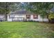 Charming single-story home featuring a spacious front yard and a cozy front porch at 3581 Midway Rd, Decatur, GA 30032