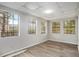 Bright room with natural light, modern flooring, and four large windows offering ample views of the outdoor scenery at 3581 Midway Rd, Decatur, GA 30032