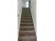 Carpeted stairway leading to the next level, featuring a sturdy banister for safety and classic interior design at 3581 Midway Rd, Decatur, GA 30032