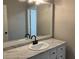 Modern bathroom vanity with marble counters, dark hardware, white sink, and updated mirror at 5073 Willow Point Pkwy, Marietta, GA 30068
