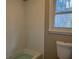 Clean bathroom featuring tiled shower/tub, with white fixtures and hardware and a standard toilet at 5073 Willow Point Pkwy, Marietta, GA 30068