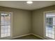 Well-lit bedroom with neutral walls, large windows offering ample natural light, and plush carpeting at 5073 Willow Point Pkwy, Marietta, GA 30068