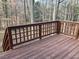 Spacious stained deck with wood railing and access stairs, perfect for enjoying the view of the wooded backyard at 5073 Willow Point Pkwy, Marietta, GA 30068