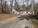Charming ranch style home with mature trees, a long driveway and neutral siding at 5073 Willow Point Pkwy, Marietta, GA 30068