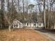 Charming ranch style home with mature trees, a long driveway and neutral siding at 5073 Willow Point Pkwy, Marietta, GA 30068
