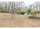Side view of the backyard showing a patio and some of the surrounding landscape at 5130 Cornwallis Ct, Stone Mountain, GA 30088