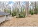 Overview of the backyard with lush trees and the side of the house visible at 5130 Cornwallis Ct, Stone Mountain, GA 30088
