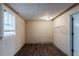 Unfinished basement with wood-look flooring, paneled walls, and a window for natural light at 5130 Cornwallis Ct, Stone Mountain, GA 30088