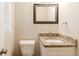 This bathroom features a granite countertop, a square framed mirror, and a modern sink at 5130 Cornwallis Ct, Stone Mountain, GA 30088