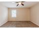 This bedroom features neutral walls, plush carpeting, a window and a ceiling fan at 5130 Cornwallis Ct, Stone Mountain, GA 30088