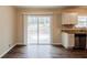This kitchen features stainless steel appliances, wood floors, granite countertops and a sliding glass door to the backyard at 5130 Cornwallis Ct, Stone Mountain, GA 30088