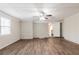 Bright living room featuring wood-look floors, a brick accent wall, and a modern ceiling fan at 5130 Cornwallis Ct, Stone Mountain, GA 30088