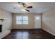 Light-filled living room has hardwood floors, a brick fireplace, and access to front door at 5130 Cornwallis Ct, Stone Mountain, GA 30088