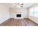 Living room features hardwood floors, a white brick fireplace, and lots of light at 5130 Cornwallis Ct, Stone Mountain, GA 30088