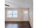 Neutral living room features hardwood floors and a white front door at 5130 Cornwallis Ct, Stone Mountain, GA 30088