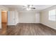 This living room features luxury vinyl plank floors, neutral paint, a ceiling fan, and a bright window at 5130 Cornwallis Ct, Stone Mountain, GA 30088