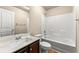 Bathroom featuring a shower-tub combo, single sink, and wood-finished cabinets at 6040 Oakley Rd, Union City, GA 30291