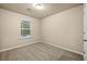 Neutral bedroom with carpeted floors, neutral walls, and a window at 6040 Oakley Rd, Union City, GA 30291