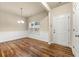 Bright dining area featuring hardwood floors and a modern light fixture at 6040 Oakley Rd, Union City, GA 30291
