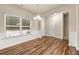 Bright dining area with hardwood floors, modern light fixture, and large windows at 6040 Oakley Rd, Union City, GA 30291