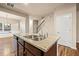 A kitchen island features a double sink, granite countertop, and dark wood cabinets at 6040 Oakley Rd, Union City, GA 30291