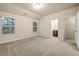 A main bedroom features a large carpeted floor, two windows, and an attached bathroom at 6040 Oakley Rd, Union City, GA 30291