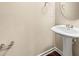 Powder room featuring a pedestal sink, mirror, and neutral wall color with towel holders at 6040 Oakley Rd, Union City, GA 30291