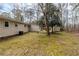 View of the backyard with trees and detached storage sheds at 8673 Chestnut Ln, Lithia Springs, GA 30122