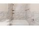 Bathroom features a white bathtub, tiled walls, shower, and mounted towel racks at 8673 Chestnut Ln, Lithia Springs, GA 30122