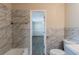 The bathroom features marble tile, a soaking tub, and modern fixtures at 8673 Chestnut Ln, Lithia Springs, GA 30122