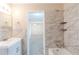 Bathroom with white tiled walls, white vanity, and view of bedroom and ceiling fan at 8673 Chestnut Ln, Lithia Springs, GA 30122