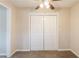 Neutral bedroom with carpeting, and closet with double doors at 8673 Chestnut Ln, Lithia Springs, GA 30122