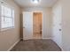 Neutral bedroom with carpeting, window with blinds, and view to bathroom at 8673 Chestnut Ln, Lithia Springs, GA 30122
