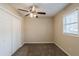 Neutral bedroom featuring carpeting, window with blinds, and ceiling fan with lighting at 8673 Chestnut Ln, Lithia Springs, GA 30122
