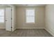 Neutral bedroom with carpeting, window with blinds, and white door leading to other rooms at 8673 Chestnut Ln, Lithia Springs, GA 30122