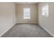Cozy bedroom with neutral paint, plush carpeting, and bright windows at 8673 Chestnut Ln, Lithia Springs, GA 30122