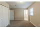 A bright bedroom features neutral walls and a closet for storage at 8673 Chestnut Ln, Lithia Springs, GA 30122