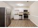 Updated kitchen featuring stainless steel appliances, granite counters, and white cabinets at 8673 Chestnut Ln, Lithia Springs, GA 30122