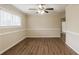 Inviting living room with wood-look flooring, a ceiling fan, and ample natural light at 8673 Chestnut Ln, Lithia Springs, GA 30122