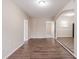 Spacious layout enhanced by wood-look flooring that leads to other rooms at 8673 Chestnut Ln, Lithia Springs, GA 30122