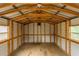 The shed interior offers open space with exposed beams and a concrete floor at 8673 Chestnut Ln, Lithia Springs, GA 30122