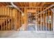 Unfinished basement with exposed wooden beams and ductwork, offering potential for customization at 12090 Lonsdale Ln, Roswell, GA 30075