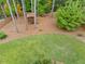 Aerial view of backyard with a playhouse, lush green lawn, and surrounding woods at 2541 Hawthorne Ne Dr, Atlanta, GA 30345